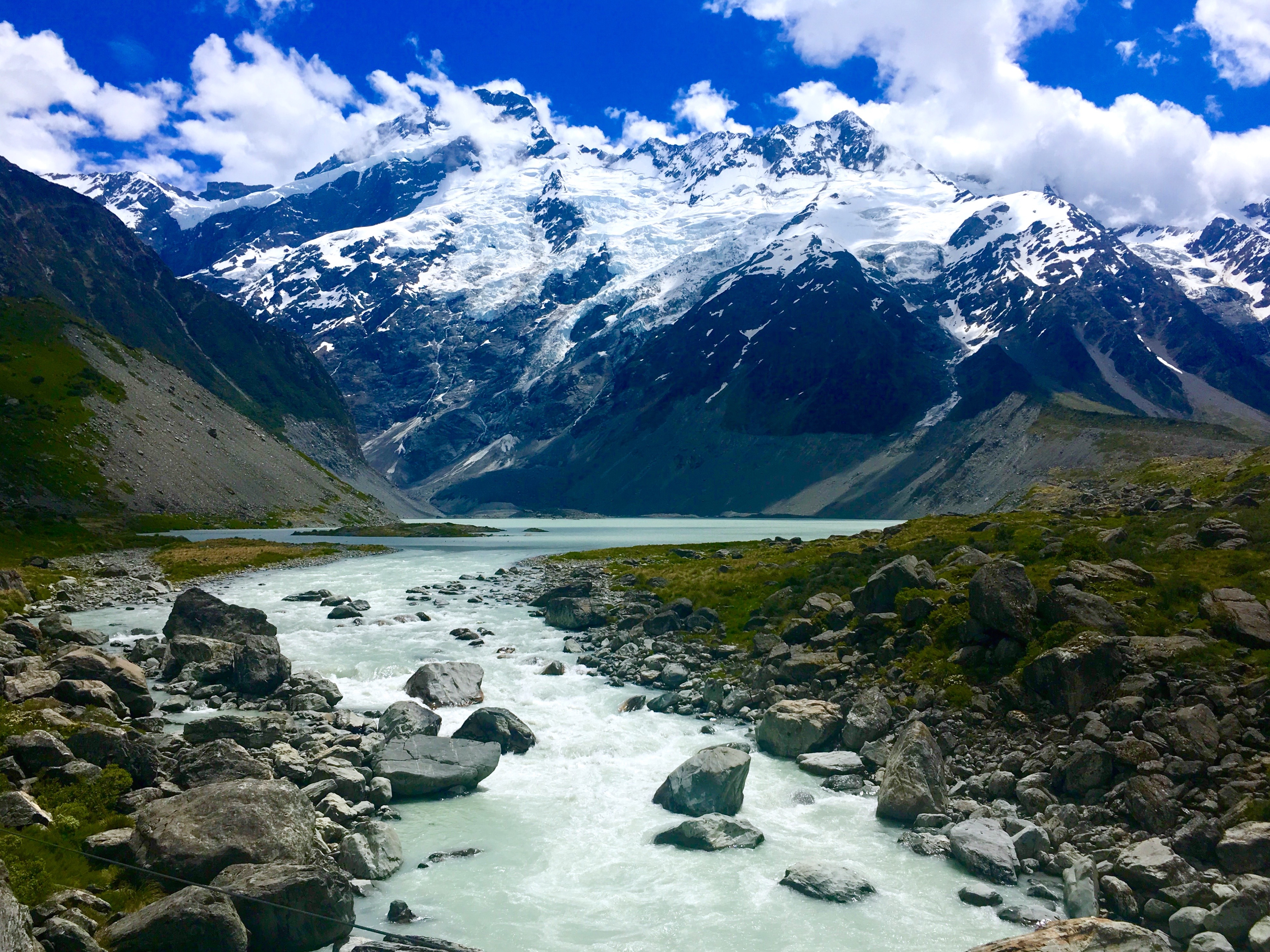 Landscape with snowy mountains and a rocky stream 