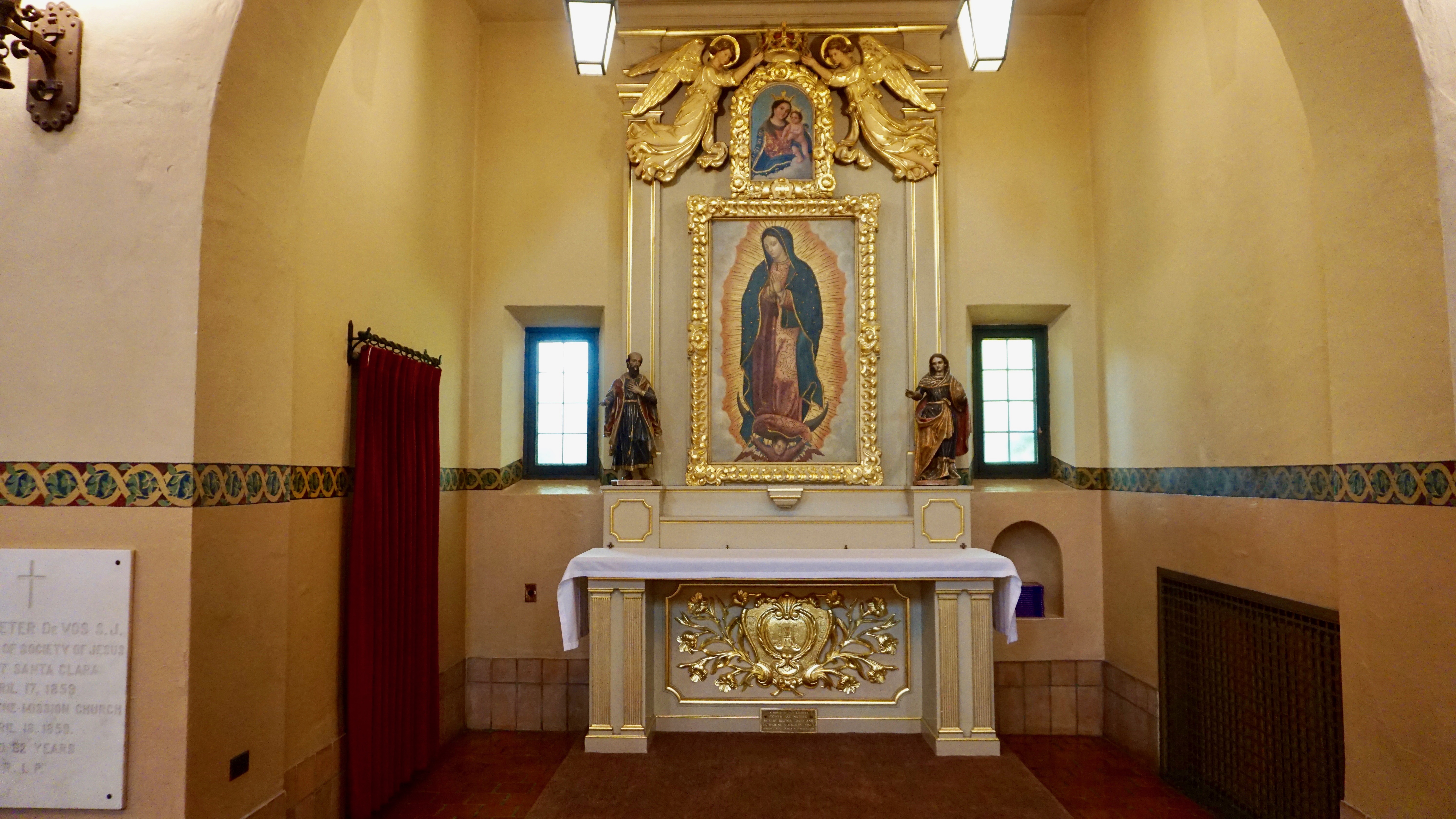 Interior of Guadalupe Sie Chapel with altar, statue, and religious decor.