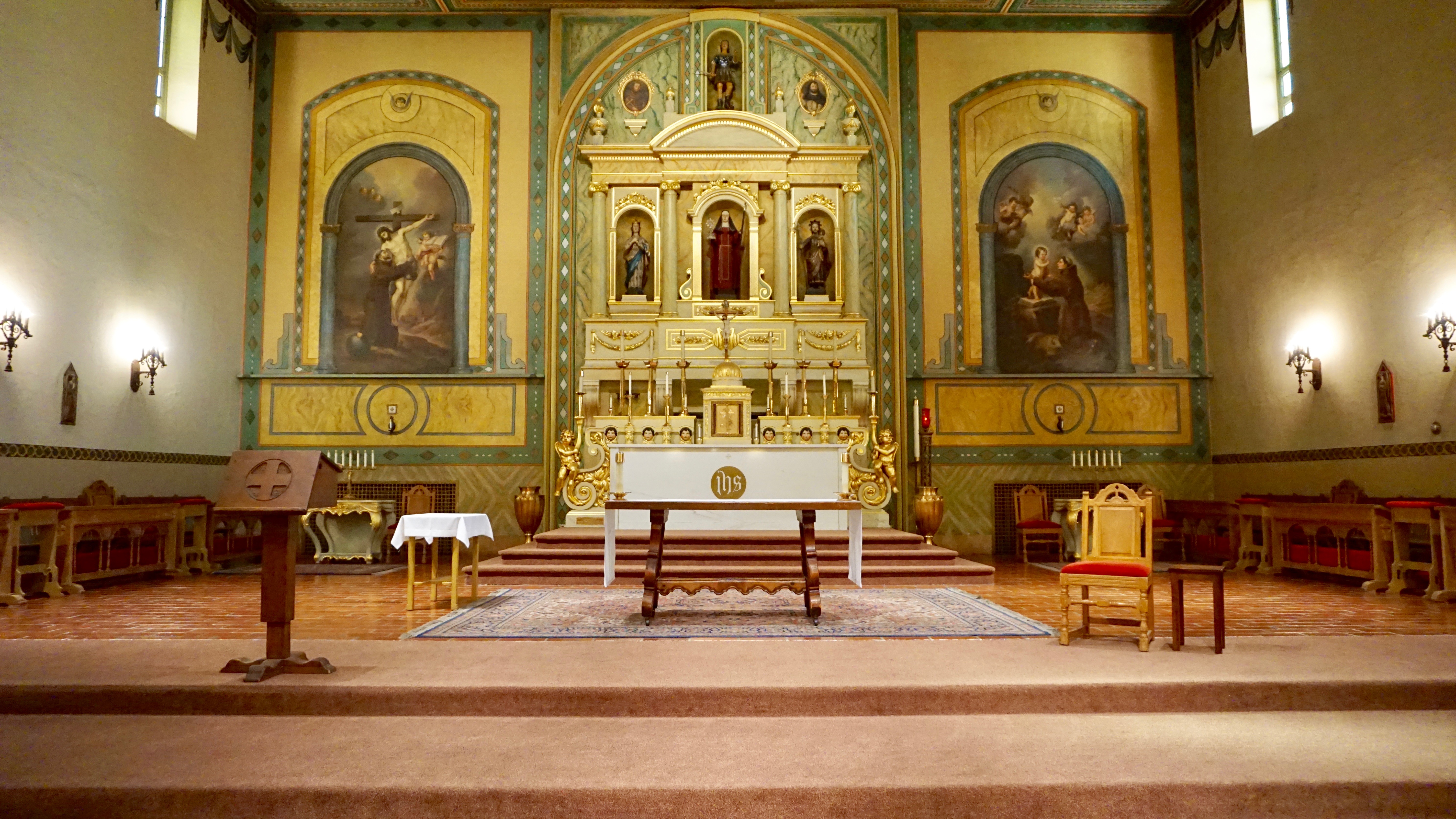 Interior view of a sanctuary with traditional religious architecture and ornate decorations.