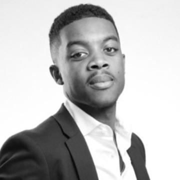 image of man with short dark hair in suit and open-collar button down shirt