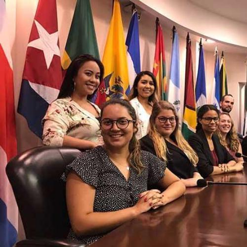 Law students smiling in a board room