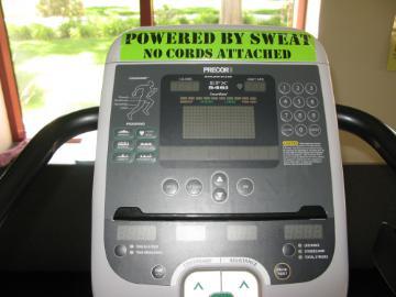 A treadmill display showing workout statistics with text 