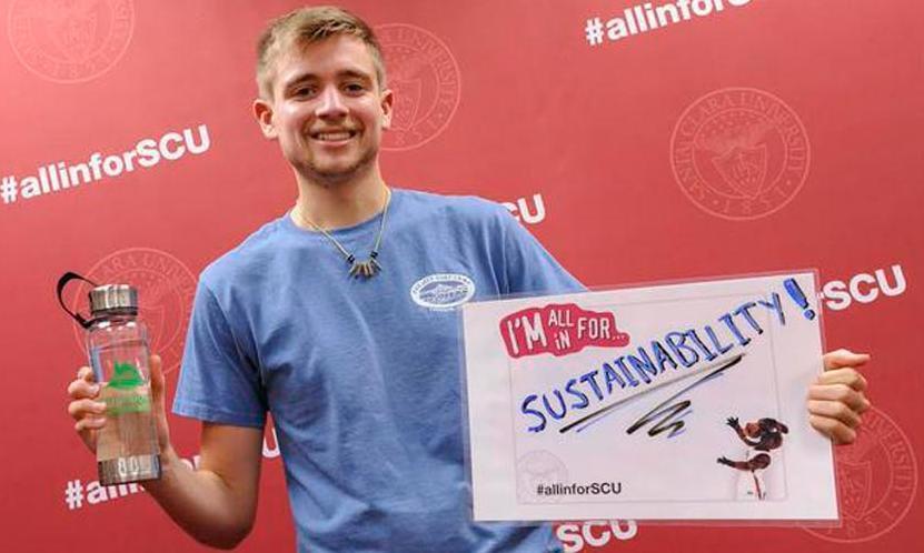 A person holds a sign reading 
