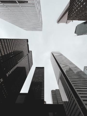 Ground view of tall grey skyscrapers in city financial district