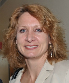 Person smiling in a light-colored outfit. image link to story