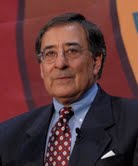 A person in a suit with a patterned tie on stage.