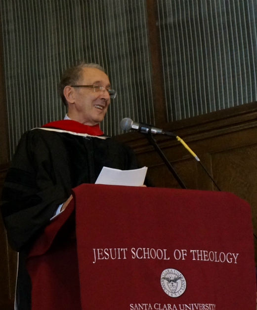 A person speaking at a podium labeled 