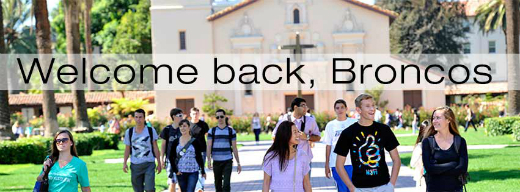 Eight people standing in front of a banner that reads 