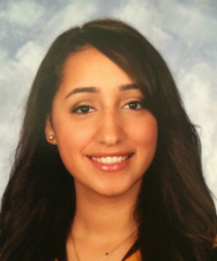 A person smiling with a cloudy background. image link to story