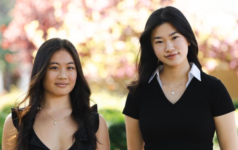 Two young women pose for the camera