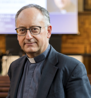 A priest posing for a headshot