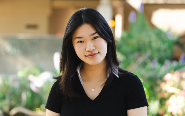 Sam Lei, a woman wearing a black top poses for the camera