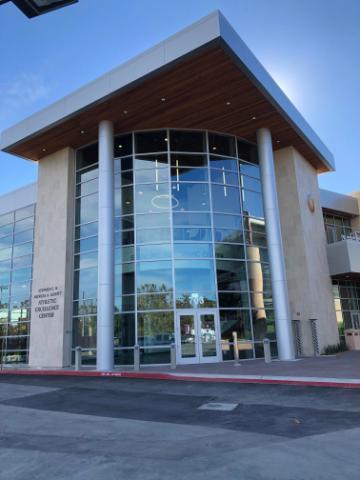 Modern building front entrance with large glass windows titled 