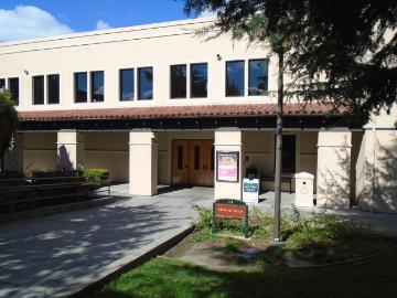 Two-story building with a sign that reads 
