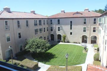 Alt text: University Villas courtyard with greenery and surrounding multi-story buildings.