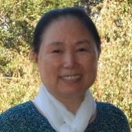 A woman named Weijia Shang smiling outdoors.