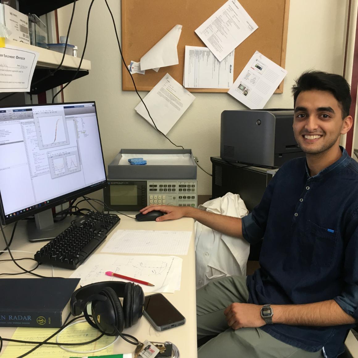 Amritpal Singh sitting in front of a computer in a lab image link to story