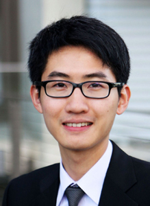 A person named On Shun Pak wearing eyeglasses and a suit, smiling.