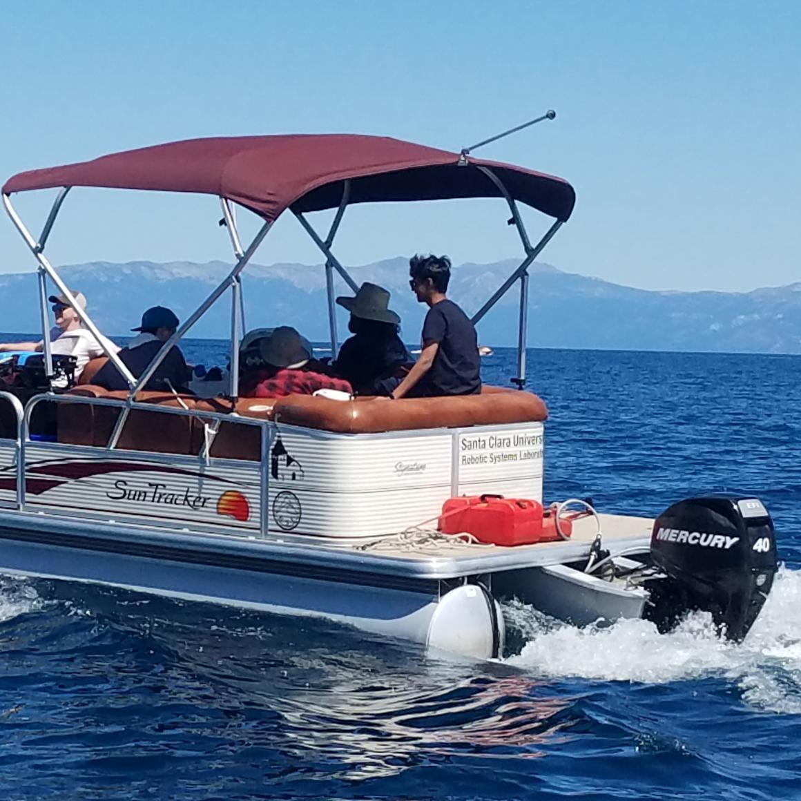 Students and faculty on a Sun Tracker motor boat on Lake Tahoe
