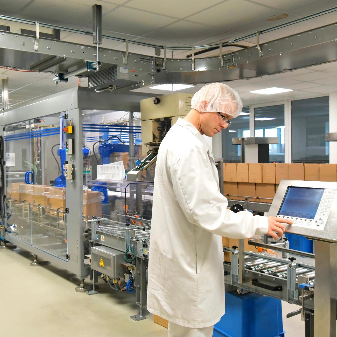 Worker in biopharmaceutical manufacturing plant at a computer