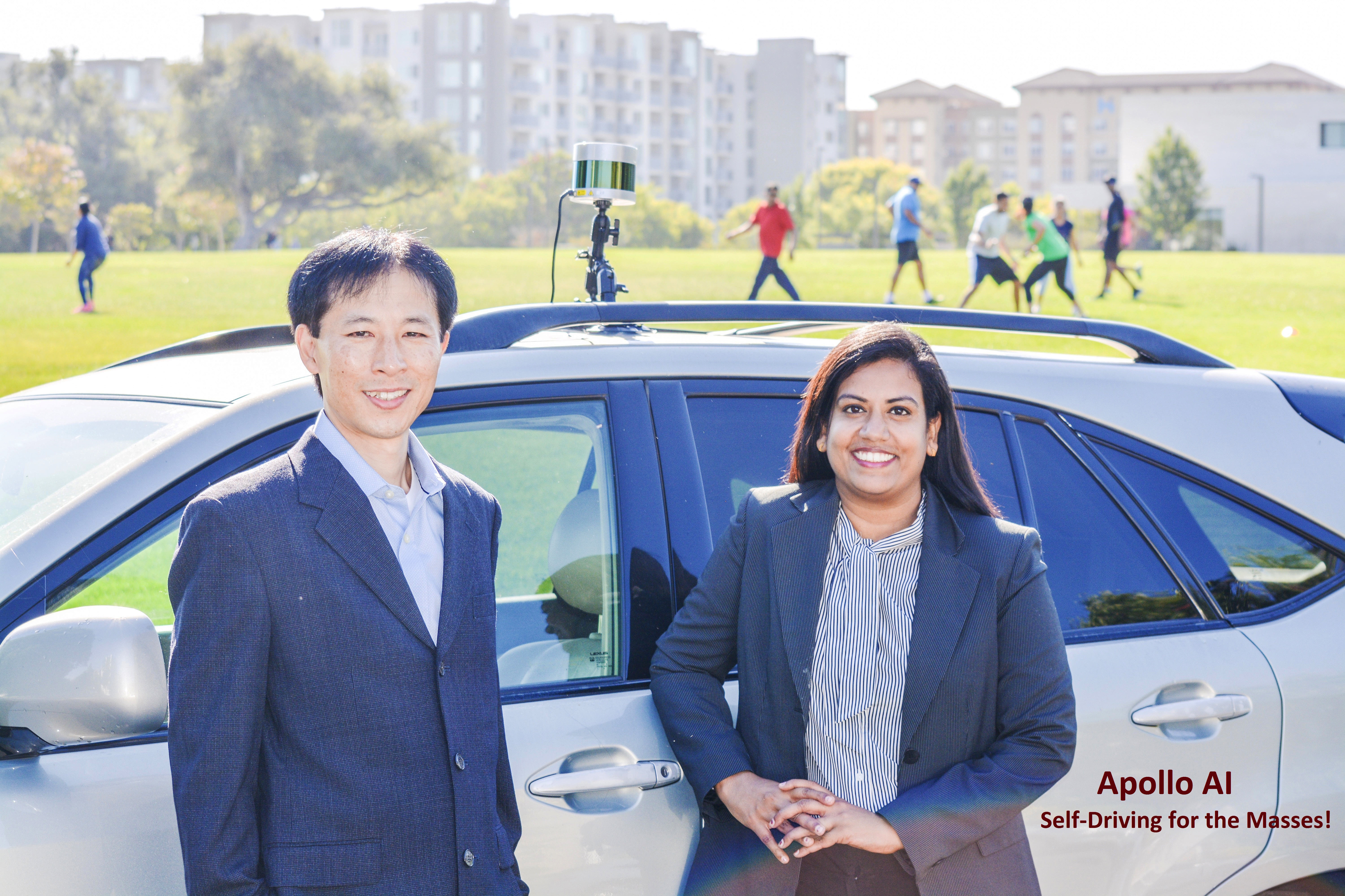 Two individuals stand in front of an AI-equipped vehicle named Apollo AI. image link to story