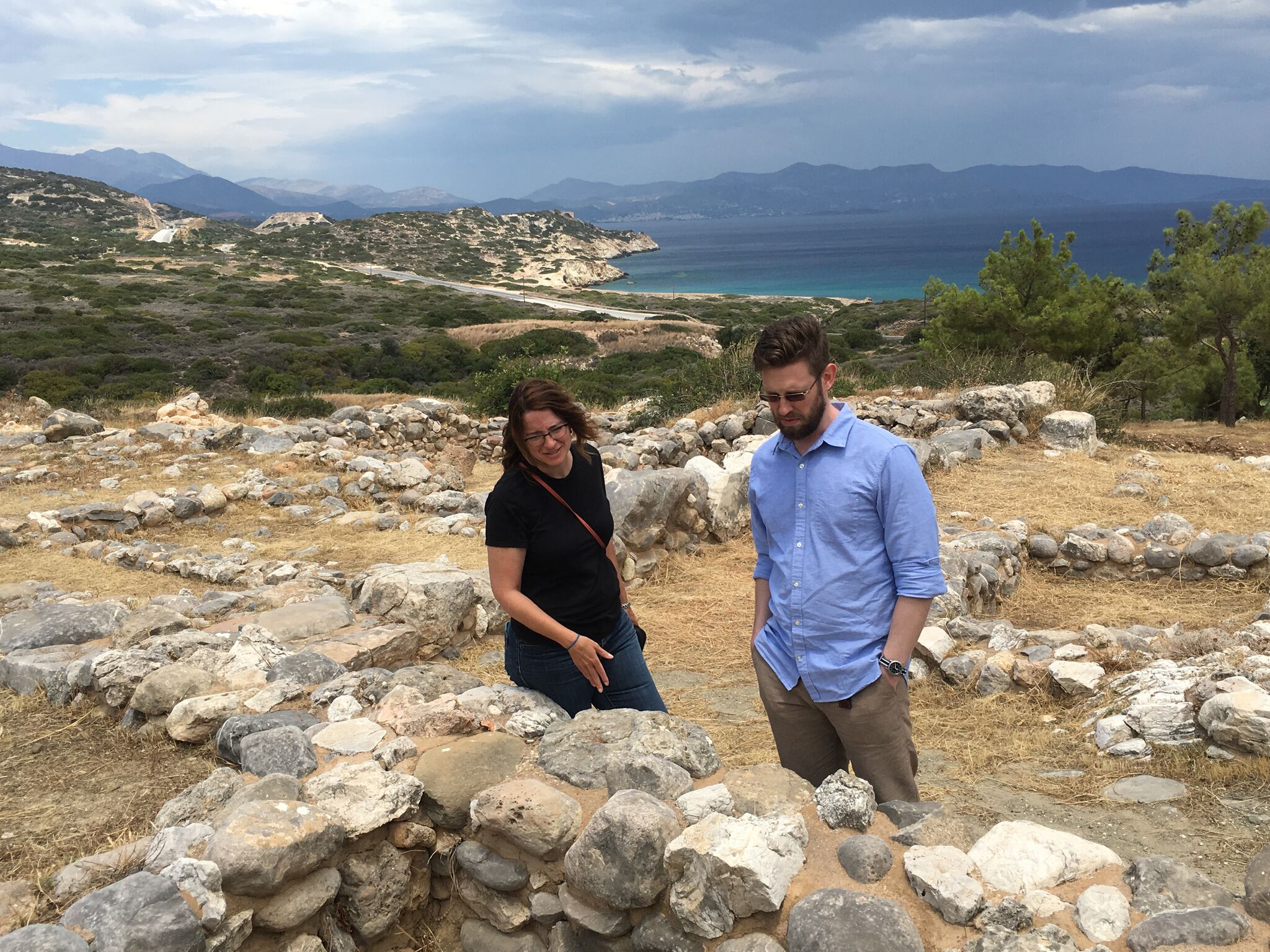 Two people standing among ancient ruins at the Minoan site in Gournia, Crete. image link to story