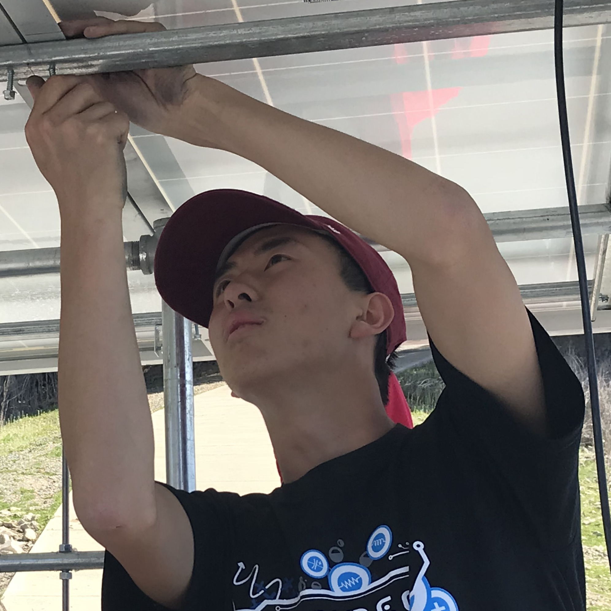 A person working on electrical wiring, wearing a cap. image link to story