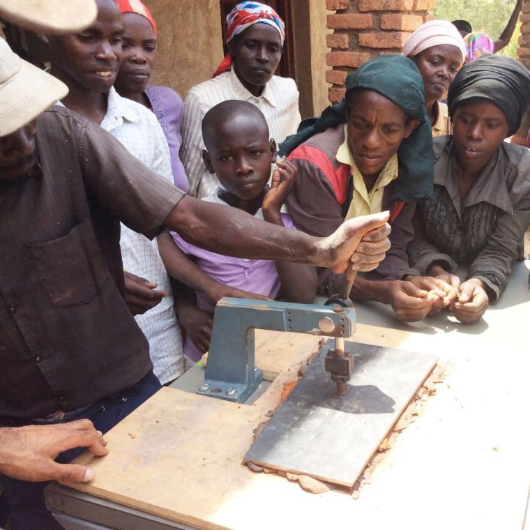 SCU students introduce their tile press to the people of Nyange, Rwanda