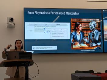 Dr Ma presenting in front of screen