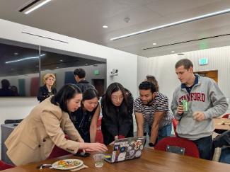 Students looking at a demo on a laptop