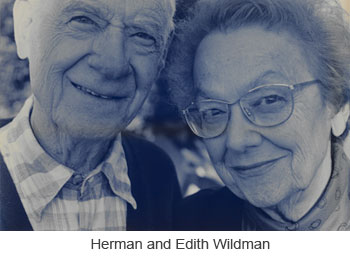 a photo of an elderly woman and man. the man is in a button down shirt and the woman has glasses