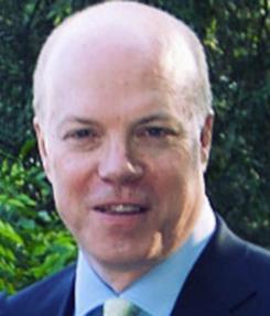 A person in a suit and tie outdoors.