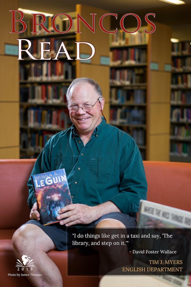 Tim sitting and holding a book